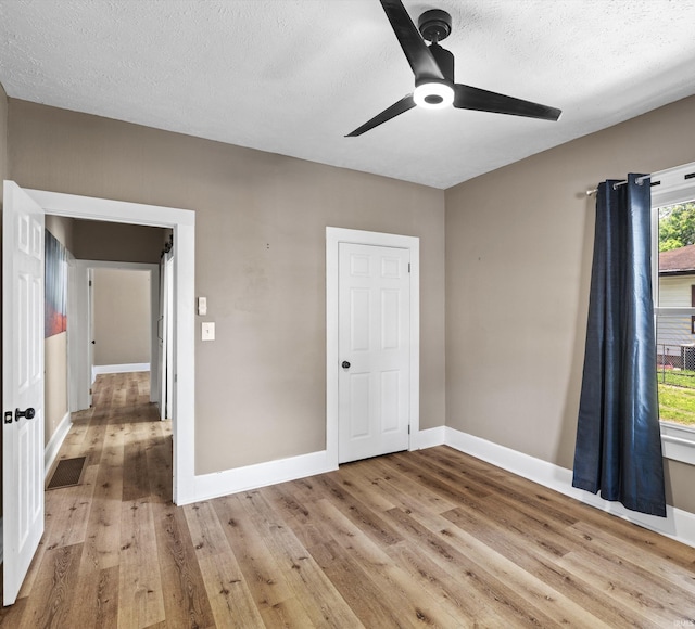 2015 E Blackford Ave, Evansville, IN 47714 - unfurnished bedroom featuring wood finished floors, a textured ceiling, and ceiling fan