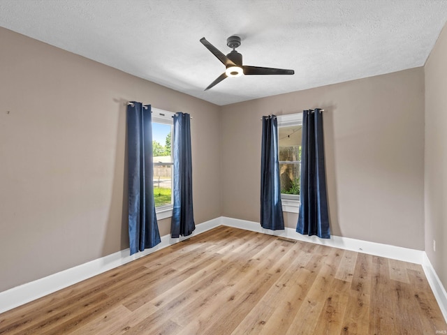 2015 E Blackford Ave, Evansville, IN 47714 - empty room featuring healthy amount of natural light, light wood-style flooring, ceiling fan, and a textured ceiling