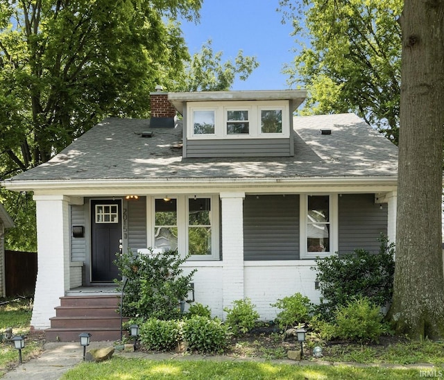 2015 E Blackford Ave, Evansville, IN 47714 - bungalow-style house featuring brick siding, covered porch, a chimney, and a shingled roof