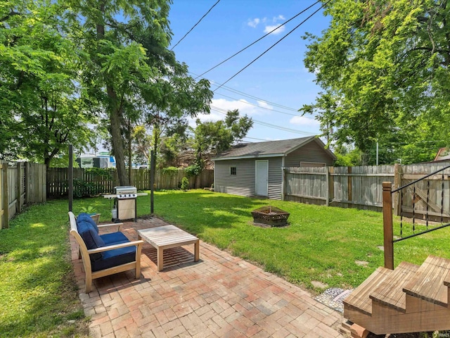 2015 E Blackford Ave, Evansville, IN 47714 - fenced backyard with a fire pit, a patio, a grill, and an outdoor structure