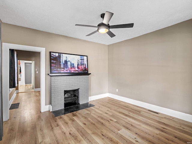 2015 E Blackford Ave, Evansville, IN 47714 - unfurnished living room with wood finished floors, a ceiling fan, and a fireplace