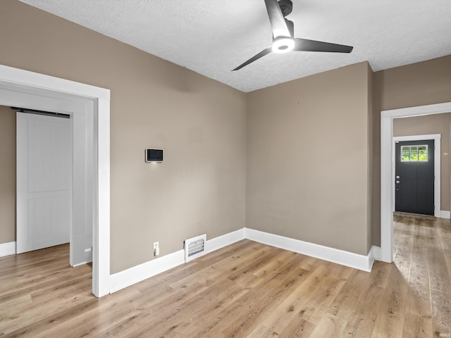 2015 E Blackford Ave, Evansville, IN 47714 - empty room featuring a ceiling fan, light wood-type flooring, and a textured ceiling
