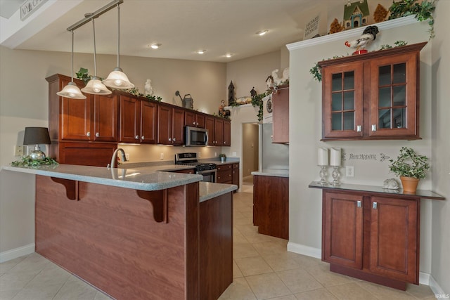6615 Leeway Dr, South Bend, IN 46628 - kitchen featuring appliances with stainless steel finishes, a kitchen breakfast bar, light tile patterned floors, a peninsula, and glass insert cabinets