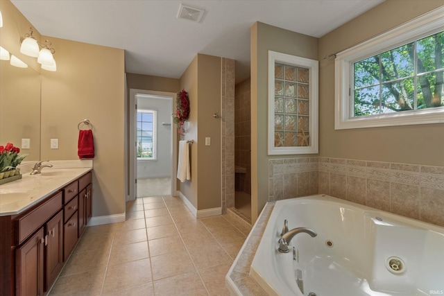 6615 Leeway Dr, South Bend, IN 46628 - bathroom with double vanity, a jetted tub, tiled shower, and tile patterned flooring