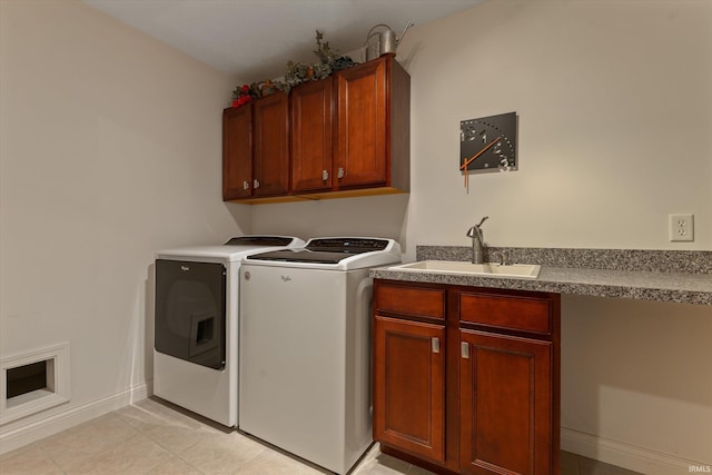 6615 Leeway Dr, South Bend, IN 46628 - laundry room featuring washer and clothes dryer, cabinet space, and light tile patterned floors