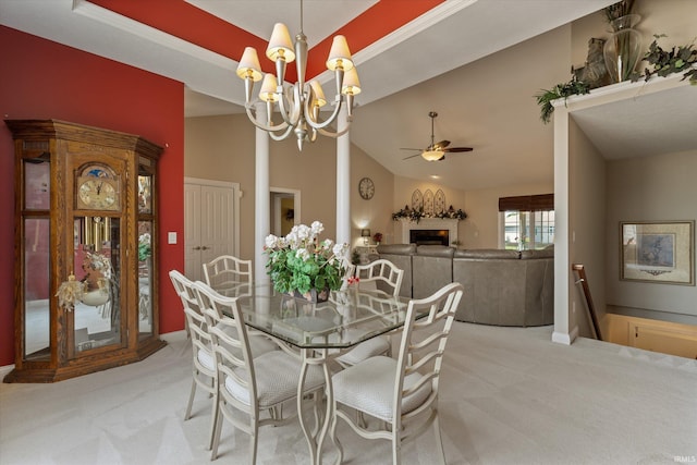 6615 Leeway Dr, South Bend, IN 46628 - dining space with light carpet, a chandelier, a ceiling fan, a fireplace, and vaulted ceiling