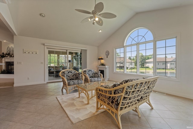 6615 Leeway Dr, South Bend, IN 46628 - living room with a fireplace, ceiling fan, light tile patterned floors, plenty of natural light, and high vaulted ceiling