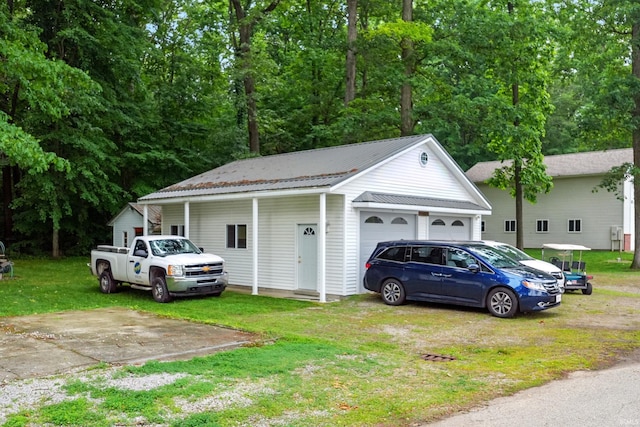 1385 S 460 E, Lagrange, IN 46761 - view of side of home with a garage, a lawn, and a metal roof