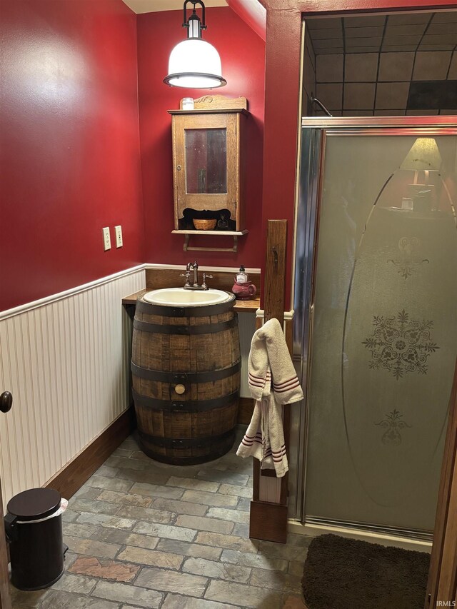 7614 N 100 W Rd, Uniondale, IN 46791 - bathroom with wainscoting, a stall shower, vanity, and brick flooring