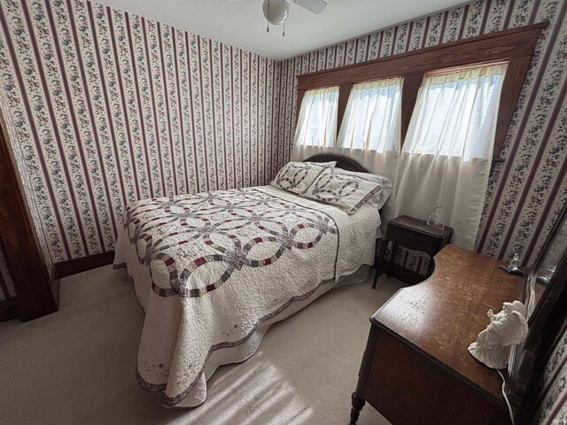 7614 N 100 W Rd, Uniondale, IN 46791 - bedroom with wallpapered walls, carpet floors, and a ceiling fan