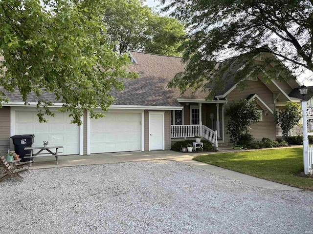 7614 N 100 W Rd, Uniondale, IN 46791 - view of front facade with roof with shingles, gravel driveway, a garage, a porch, and a front lawn