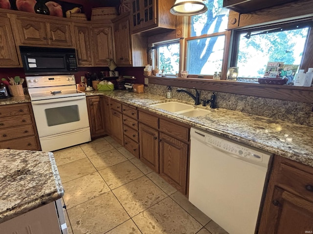 7614 N 100 W Rd, Uniondale, IN 46791 - kitchen featuring white appliances, light tile patterned floors, light stone counters, and brown cabinets