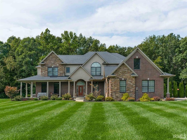 1130 Kingswood Rd, West Lafayette, IN 47906 - view of front of house featuring a front yard, stucco siding, and stone siding