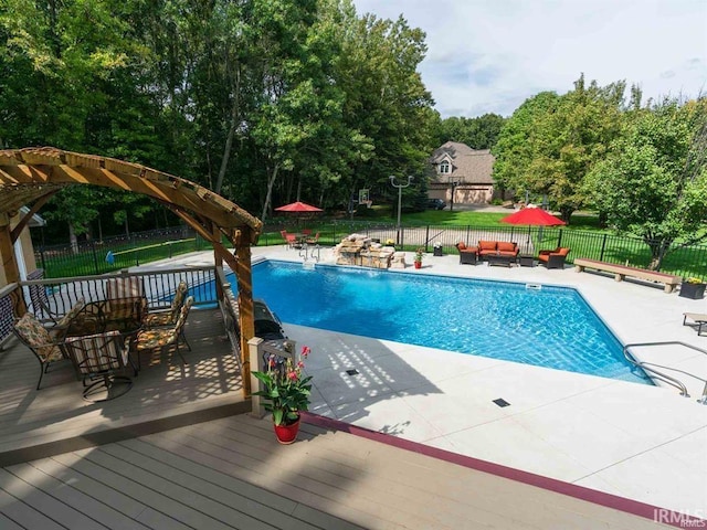 1130 Kingswood Rd, West Lafayette, IN 47906 - view of swimming pool featuring outdoor lounge area, a deck, a fenced backyard, view of wooded area, and a patio area