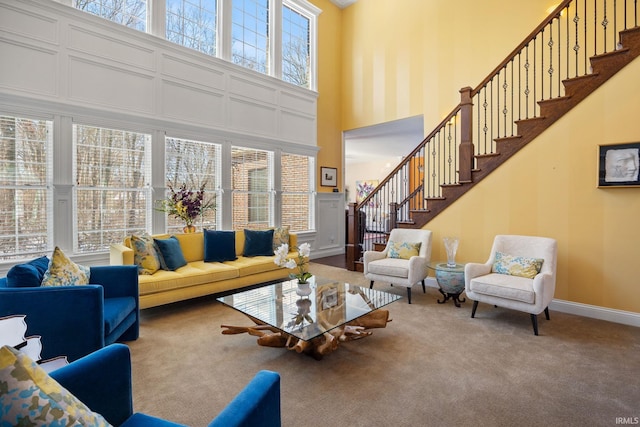 1130 Kingswood Rd, West Lafayette, IN 47906 - carpeted living room featuring a high ceiling and stairway