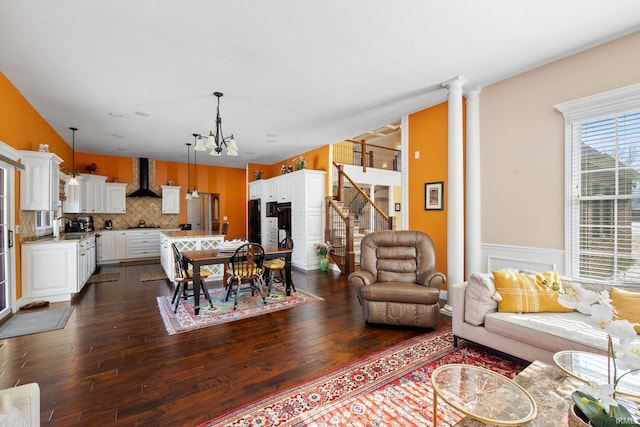 1130 Kingswood Rd, West Lafayette, IN 47906 - living area with a chandelier, stairway, dark wood-type flooring, and a wainscoted wall
