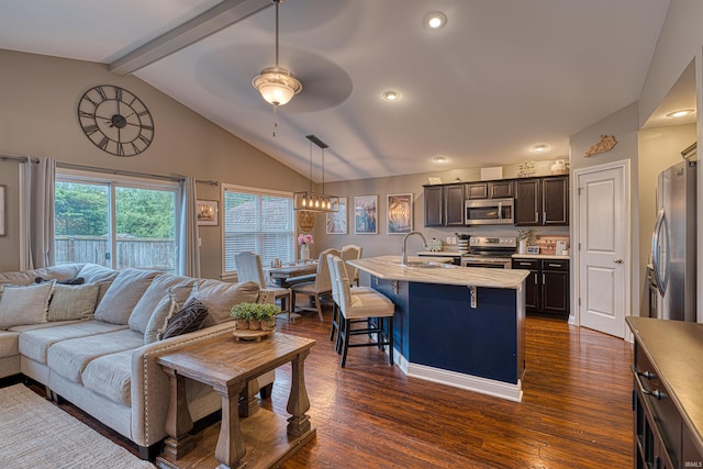2407 Ellington Ridge Dr, Evansville, IN 47711 - kitchen with appliances with stainless steel finishes, open floor plan, light countertops, a kitchen breakfast bar, and dark brown cabinets