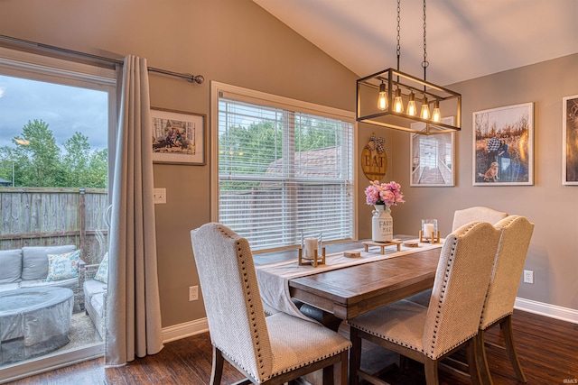 2407 Ellington Ridge Dr, Evansville, IN 47711 - dining area featuring dark wood finished floors, vaulted ceiling, and a chandelier
