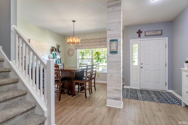 297 Indigo St, Lafayette, IN 47909 - entryway featuring light wood-type flooring, a chandelier, and stairway