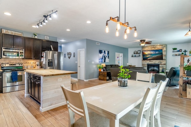 297 Indigo St, Lafayette, IN 47909 - dining space featuring ceiling fan, a stone fireplace, light wood finished floors, and recessed lighting