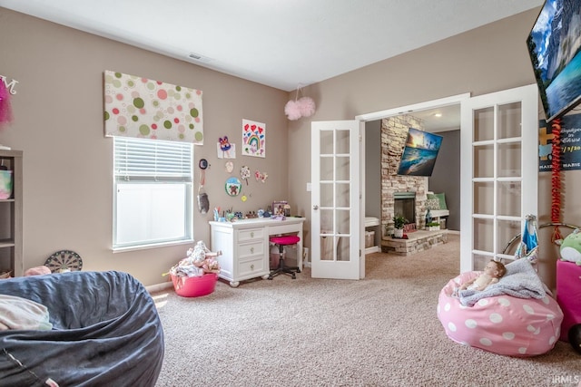 297 Indigo St, Lafayette, IN 47909 - playroom featuring carpet, french doors, a fireplace, and a desk