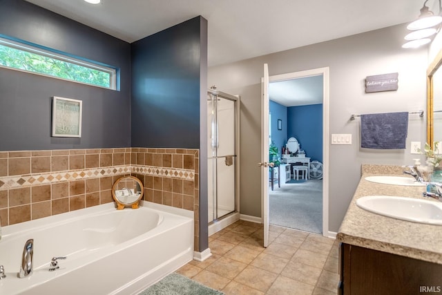 297 Indigo St, Lafayette, IN 47909 - bathroom featuring a garden tub, a stall shower, double vanity, and tile patterned flooring
