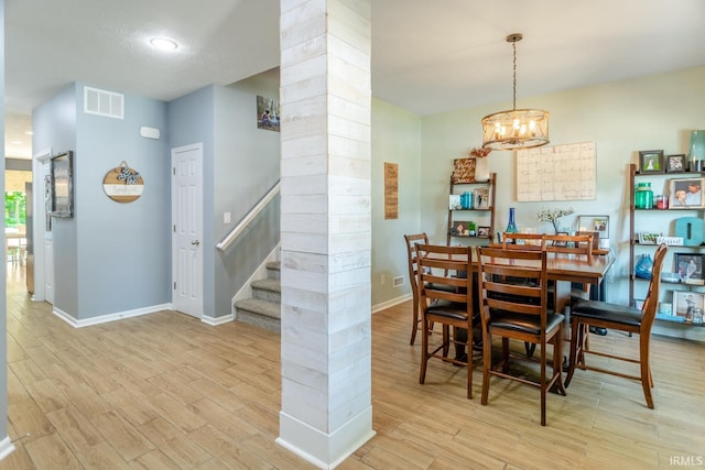 297 Indigo St, Lafayette, IN 47909 - dining area featuring decorative columns, stairway, wood finished floors, and a chandelier