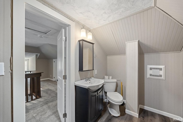 621 S 28th St, Lafayette, IN 47904 - half bathroom featuring vaulted ceiling, vanity, and wood finished floors