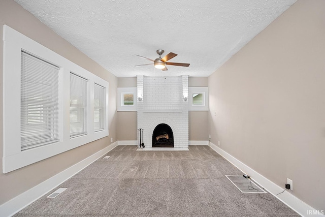621 S 28th St, Lafayette, IN 47904 - unfurnished living room with ceiling fan, carpet flooring, healthy amount of natural light, a brick fireplace, and a textured ceiling