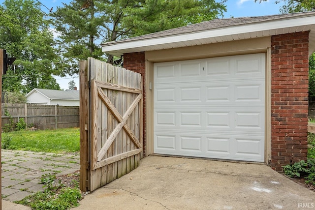 621 S 28th St, Lafayette, IN 47904 - garage featuring concrete driveway and a gate