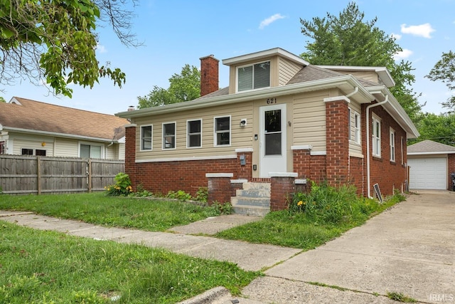 621 S 28th St, Lafayette, IN 47904 - bungalow featuring entry steps, brick siding, a chimney, and a garage