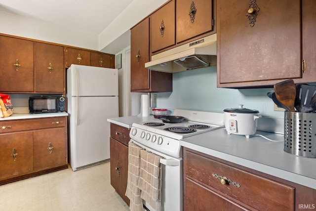 309 Highland Dr, West Lafayette, IN 47906 - kitchen featuring white appliances, under cabinet range hood, light countertops, and brown cabinetry