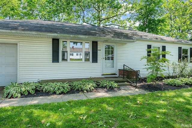 309 Highland Dr, West Lafayette, IN 47906 - view of front of home featuring an attached garage, a shingled roof, and a front yard