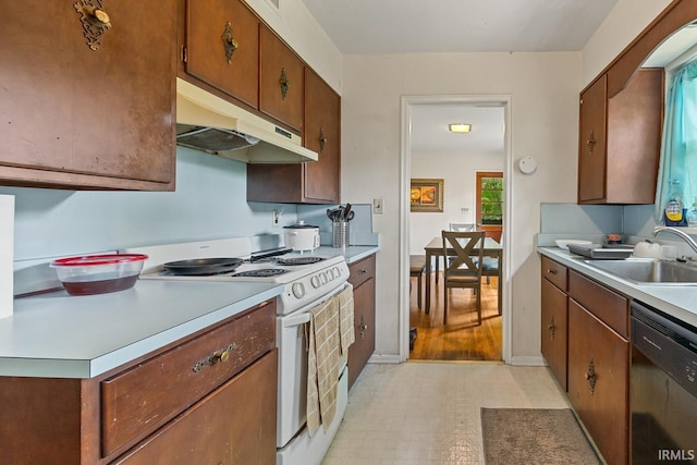 309 Highland Dr, West Lafayette, IN 47906 - kitchen with white electric range oven, under cabinet range hood, dishwasher, light countertops, and brown cabinetry
