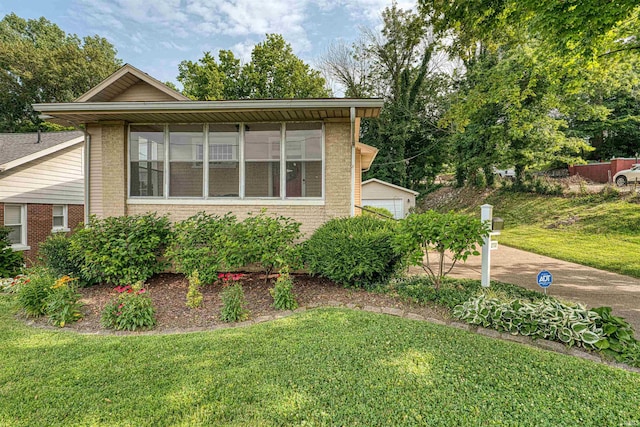 2732 Pennsylvania St, Evansville, IN 47712 - view of front of house with a front yard, brick siding, and an outdoor structure