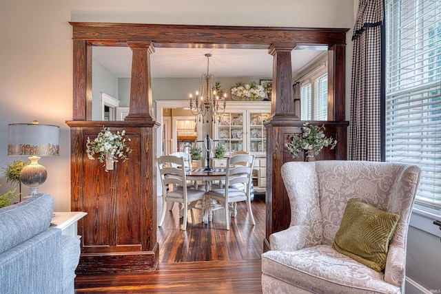 2732 Pennsylvania St, Evansville, IN 47712 - dining area featuring decorative columns, healthy amount of natural light, a chandelier, and hardwood / wood-style flooring