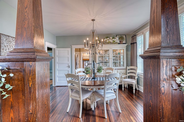 2732 Pennsylvania St, Evansville, IN 47712 - dining space featuring dark wood finished floors, a chandelier, and decorative columns