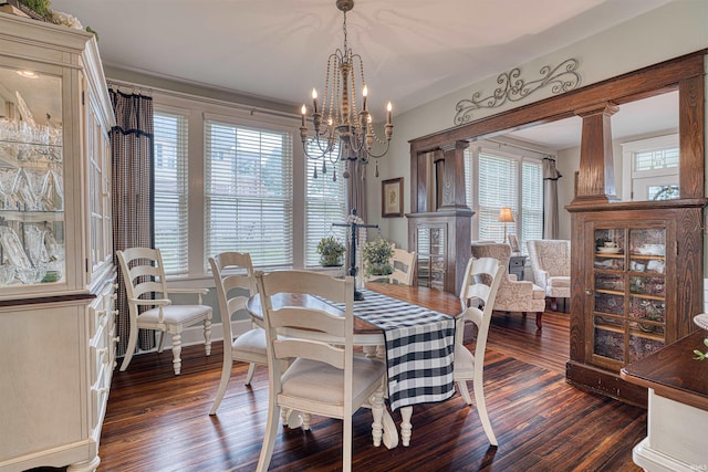 2732 Pennsylvania St, Evansville, IN 47712 - dining room featuring a chandelier, wood finished floors, and decorative columns