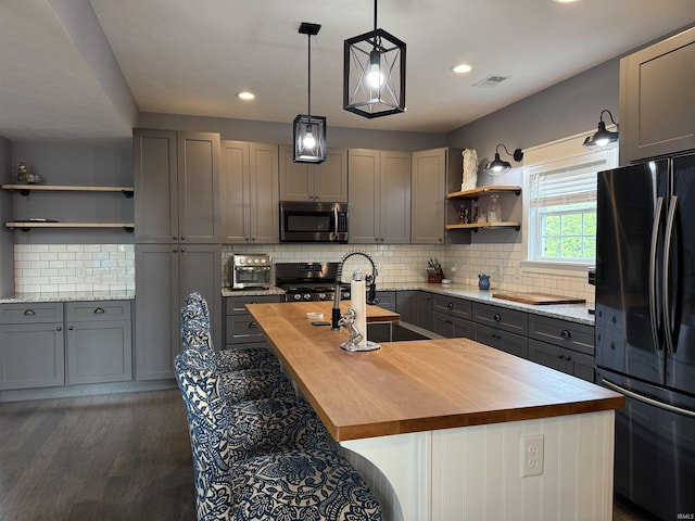 1285 E Zinnia Dr, Bloomington, IN 47401 - kitchen featuring butcher block counters, stainless steel appliances, open shelves, gray cabinets, and recessed lighting