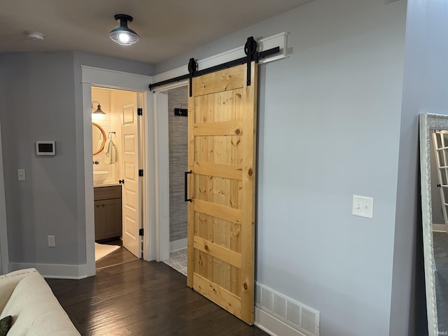 1285 E Zinnia Dr, Bloomington, IN 47401 - bedroom with dark wood-style flooring, a barn door, and ensuite bath