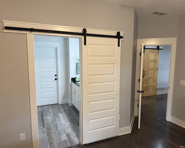 1285 E Zinnia Dr, Bloomington, IN 47401 - hall featuring a barn door and dark wood-style floors