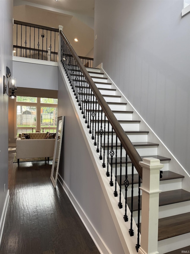 1285 E Zinnia Dr, Bloomington, IN 47401 - staircase featuring hardwood / wood-style flooring and a towering ceiling
