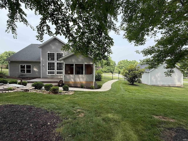 1285 E Zinnia Dr, Bloomington, IN 47401 - back of property featuring a sunroom, a patio, and roof with shingles