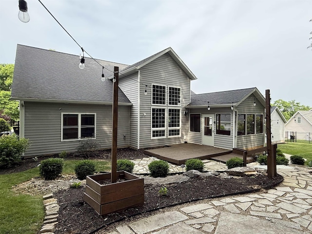 1285 E Zinnia Dr, Bloomington, IN 47401 - rear view of house with a sunroom, a wooden deck, and a shingled roof