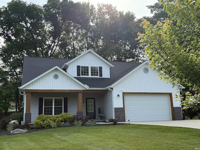1285 E Zinnia Dr, Bloomington, IN 47401 - view of front of property featuring a front lawn, an attached garage, roof with shingles, driveway, and covered porch