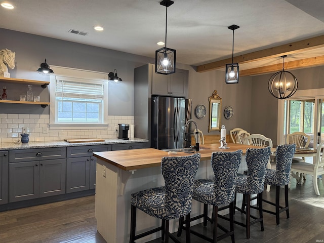 1285 E Zinnia Dr, Bloomington, IN 47401 - kitchen with butcher block countertops, freestanding refrigerator, gray cabinets, backsplash, and plenty of natural light