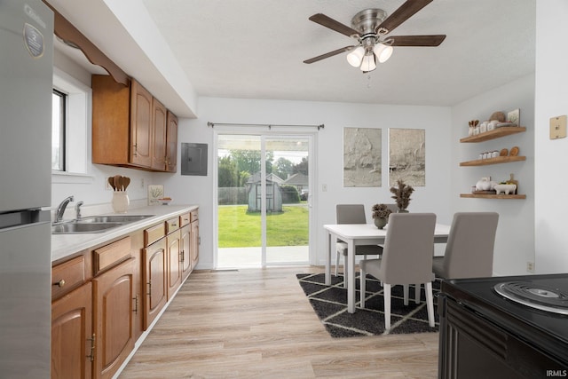 115 S 27th St, Lafayette, IN 47904 - kitchen featuring freestanding refrigerator, open shelves, light wood-style flooring, a ceiling fan, and light countertops