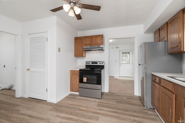 115 S 27th St, Lafayette, IN 47904 - kitchen featuring appliances with stainless steel finishes, under cabinet range hood, a ceiling fan, light countertops, and a textured ceiling