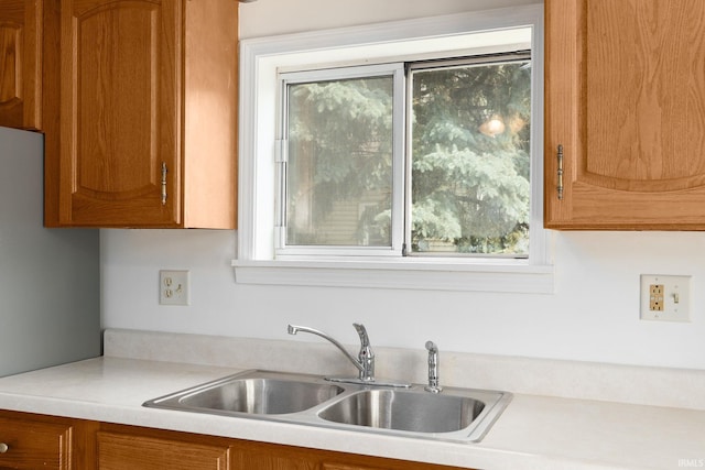 115 S 27th St, Lafayette, IN 47904 - kitchen featuring light countertops, healthy amount of natural light, and brown cabinetry