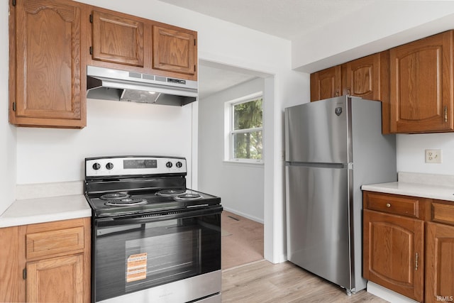 115 S 27th St, Lafayette, IN 47904 - kitchen with stainless steel appliances, under cabinet range hood, light countertops, and light wood-type flooring